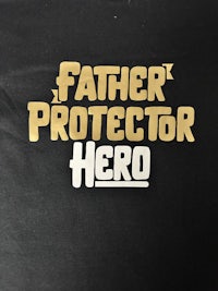 a black t - shirt that says father protector hero