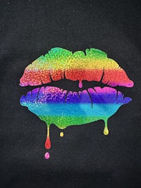 a black t - shirt with a rainbow lipstick on it