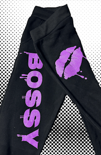 a pair of black sweatpants with the word bossy on them